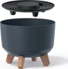 A dark gray planter pot with a black insert and three brown legs, shown against a white background. Podgląd zdjęcia produktu