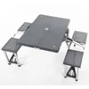 A portable picnic table with four attached seats, shown folded and set up. Produktbild-Vorschau