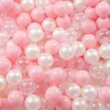 A close-up view of many pink and white balls. Produktbild-Vorschau