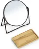 A round black metal makeup mirror with a stand and a small wooden tray are shown on a white background. Podgląd zdjęcia produktu