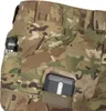 A close-up view of camouflage pants with various pockets. A flashlight is in one pocket, and a phone is in another. There is also a zipper pocket visible. Produktbild-Vorschau