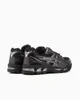 A pair of black ASICS Gel-Kayano 14 sneakers with silver accents, shown from a rear-side angle against a white background. Produktbild-Vorschau