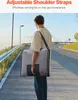 A person walking on a path carrying a bag. Voir les images du produit