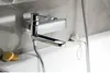 A close-up shot of a modern chrome bathtub faucet mounted on a tiled wall above a white bathtub. Náhľad obrázku produktu