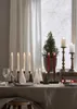 A table setting with candles and a small Christmas tree. Produktbild-Vorschau