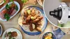 A spread of Middle Eastern food with a close-up of a meat grinder attachment. Podgląd zdjęcia produktu
