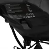 A close-up view of a black fabric label with text and symbols, attached to a stroller. Náhľad obrázku produktu