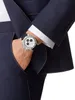 A man's hand wearing a watch is placed in the pocket of a suit. Produktbild-Vorschau
