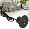 A close-up of a black dual USB charging port with a cable, superimposed over a blurred image of a living room with a sofa and armchair. Voir les images du produit