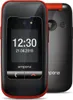 A product shot of a flip phone, with a second phone visible in the background. Podgląd zdjęcia produktu