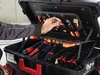 A person's hand is reaching into an open tool case, selecting a tool. Produktbild-Vorschau