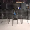 A table and chairs set in front of a tiled bar. Produktbild-Vorschau