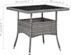 A grey rattan table with a glass top and a storage compartment underneath, shown with dimensions indicated by text overlays. Náhľad obrázku produktu