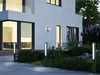 Modern house exterior at dusk with pathway lights illuminating the garden and walkway. Anteprima dell’immagine prodotto