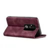 A burgundy flip case for a smartphone is shown from the side, with the phone partially inserted and the camera module visible. Produktbild-Vorschau