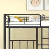 Close-up view of the top bunk of a black metal bunk bed with white bedding, a yellow pillow, and stuffed animals. Voir les images du produit