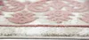 A close-up, angled view of the edge of a rug with a vintage-inspired floral pattern. Produktbild-Vorschau