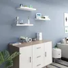 A modern living room with a credenza and shelves displaying decorative items. Produktbild-Vorschau