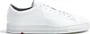 A white leather sneaker is shown from the side against a white background. Voir les images du produit