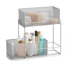 A two-tiered silver mesh organizer filled with various toiletries and bath products. Produktbild-Vorschau