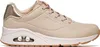 A side view of a beige Skechers sneaker with gold accents. Produktbild-Vorschau