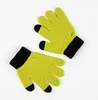 A pair of yellow gloves with black cuffs and fingertips are laid out on a white background. Podgląd zdjęcia produktu
