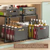 A kitchen cabinet organizer with two pull-out drawers, filled with various bottles and jars. Produktbild-Vorschau