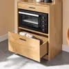 A kitchen cabinet with an open drawer and a microwave. Produktbild-Vorschau