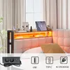 A bed with a headboard featuring integrated shelves, lighting, and charging ports, with a power strip shown in the foreground. Podgląd zdjęcia produktu