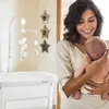 A mother is holding her baby in a nursery. Produktbild-Vorschau