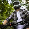 A person riding a bicycle with a helmet and goggles, with an action camera mounted on the handlebars. Náhľad obrázku produktu