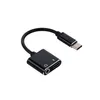 A black USB-C to 3.5mm audio adapter with a charging port. Produktbild-Vorschau