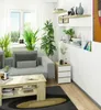 A modern living room with a sofa, coffee table, and nightstand. Produktbild-Vorschau