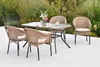 A patio dining set with four chairs and a glass-topped table, set on a light-colored patio with greenery in the background. Produktbild-Vorschau