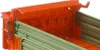 Close-up view of the interior of a toy truck bed, showing orange and green plastic components. Náhled obrázku produktu