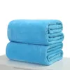 Two folded blue blankets are stacked on top of each other on a white surface against a white background. Produktbild-Vorschau