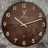 A wooden wall clock with a rustic background. Voir les images du produit