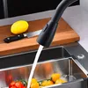 A kitchen faucet is shown with water running into a sink filled with tomatoes and lemons on a cutting board nearby. Produktbild-Vorschau
