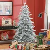 A decorated Christmas tree in a living room setting with gifts underneath and other festive decorations. Náhled obrázku produktu