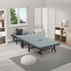 A guest bed is set up in a room with a window, a bookshelf, and a folding screen. Produktbild-Vorschau