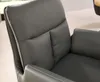 A close-up view of a gray leather armchair, focusing on the stitching and texture of the material. Produktbild-Vorschau