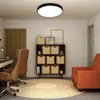 A modern home office or living space with a desk, chair, bookshelf, and accent chair. Produktbild-Vorschau