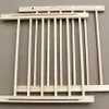 Two wooden baby gates are laid out on a brown surface. Voir les images du produit