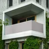A modern balcony with a grey privacy screen and lush green ivy growing on the building. Produktbild-Vorschau