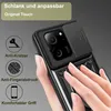 A hand is holding a black phone case with a camera cover and a ring holder. There are icons and text describing the features of the case. Produktbild-Vorschau