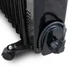 Close-up of the bottom of a black oil-filled radiator, showing a wheel and the power cord plugged into the unit. Podgląd zdjęcia produktu