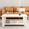 A white coffee table is placed in front of a brown leather sofa in a living room. Náhled obrázku produktu