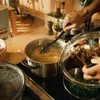A person is cooking pasta in a pot on a stovetop. Podgląd zdjęcia produktu