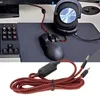 A computer setup with a keyboard, mouse, and headphones, with a close-up of a headphone cable in the foreground. Podgląd zdjęcia produktu