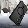 A black and transparent phone case with a magnetic ring is shown diagonally on a textured gray surface, with a blurred urban background. Podgląd zdjęcia produktu